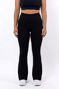 Woman wearing a black sports bra and flare leggings