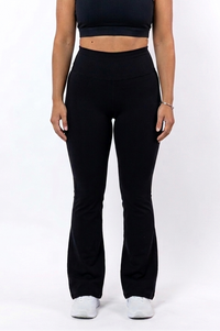 Woman wearing a black sports bra and flare leggings