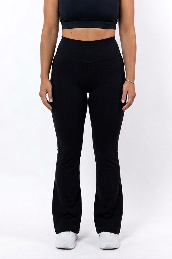 Woman wearing a black sports bra and flare leggings