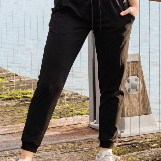 Woman wearing black athletic pants with pockets