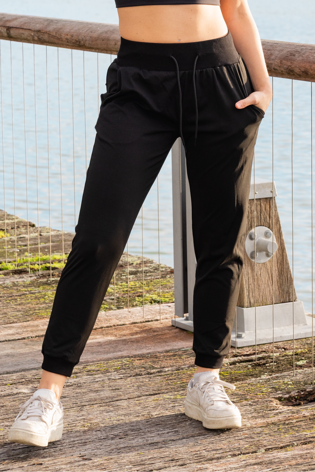 Woman wearing black athletic pants with pockets
