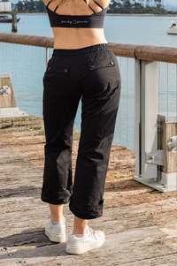 Women wearing black athletic walking pants and a sports bra.