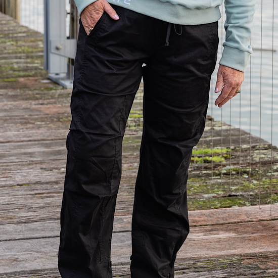 Women wearing black athletic walking pants and a sports bra.