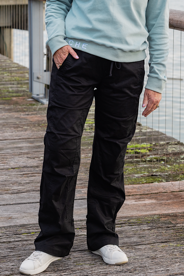Women wearing black athletic walking pants and a sports bra.