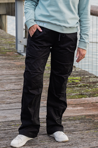 Women wearing black athletic walking pants and a sports bra.