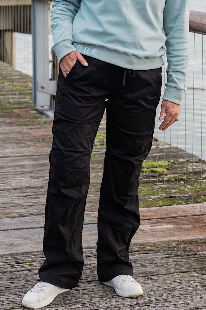 Women wearing black athletic walking pants and a sports bra.