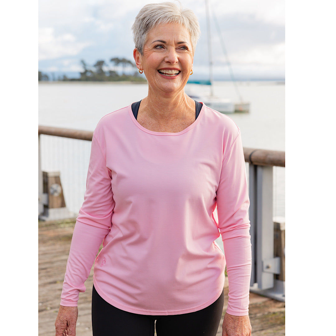 Mature woman wearing a pink long-sleeve top 