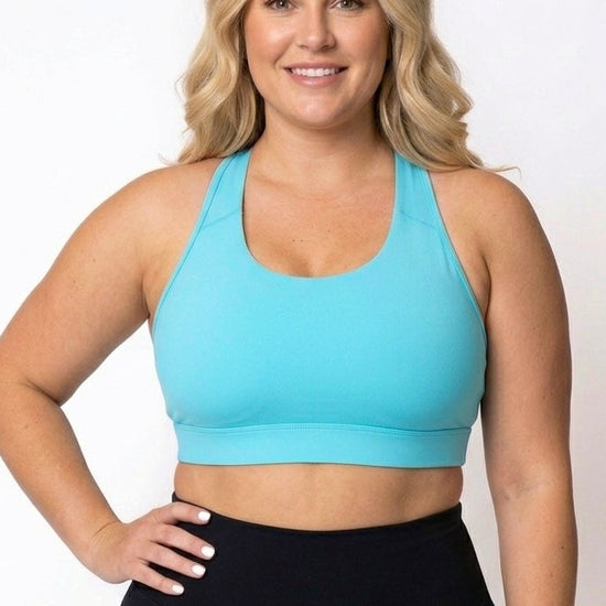 women wearing high coverage teal sports bra