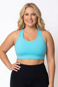women wearing high coverage teal sports bra