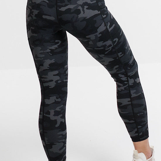 Woman in camouflage phone pocket leggings.