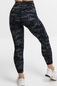 Woman in camouflage phone pocket leggings.