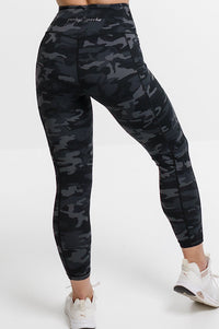 Woman in camouflage phone pocket leggings.