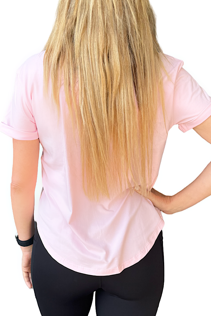 Women wearing a pink t-shirt and black tights.