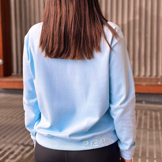 Women wearing a light blue cotton sweatshirt.