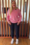 Curvy women wearing black non roll down leggings.