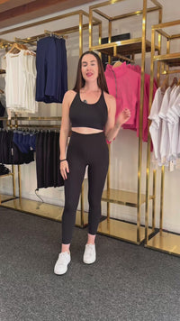 women explaining high waisted phone pocket leggings.